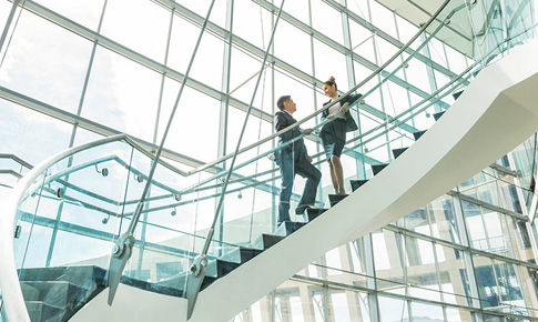Two business professional talking on stairs