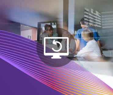 Female doctors discussing at laptop desk