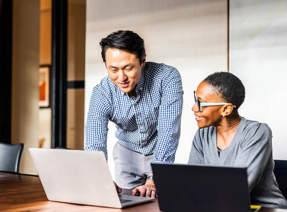 Team discussing on laptop